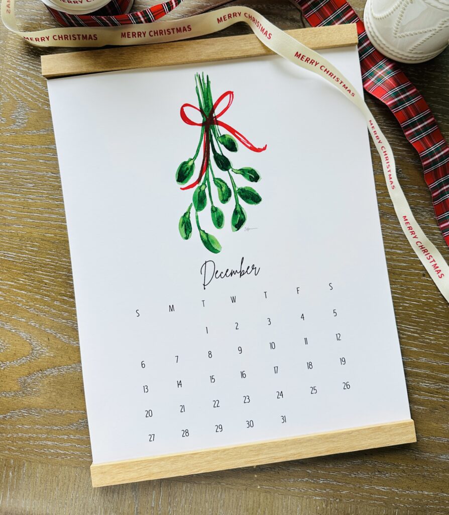 11x14 Watercolor Wall Calendar laying on a desk 